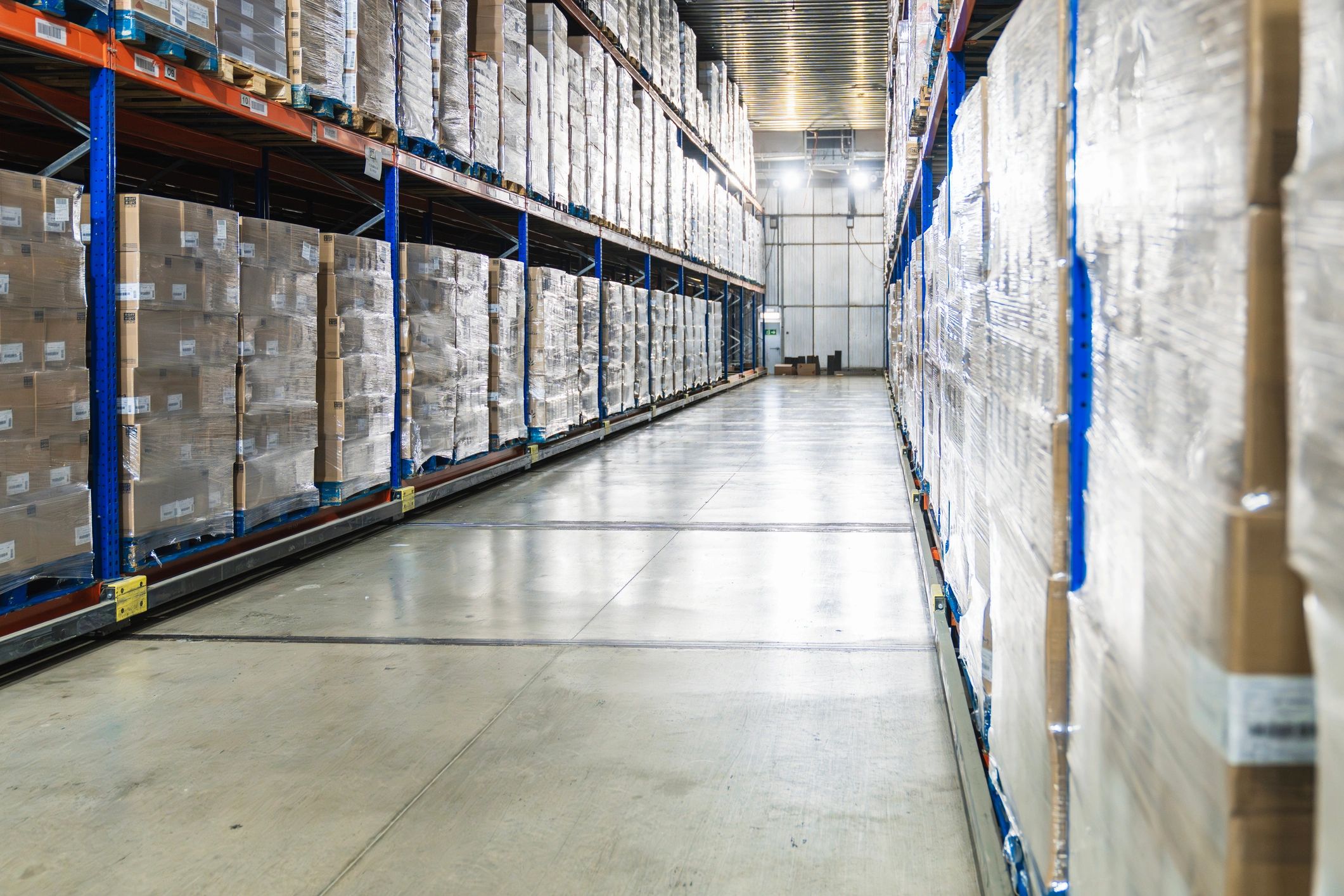 Logistics warehouse aisle with palletized cargo